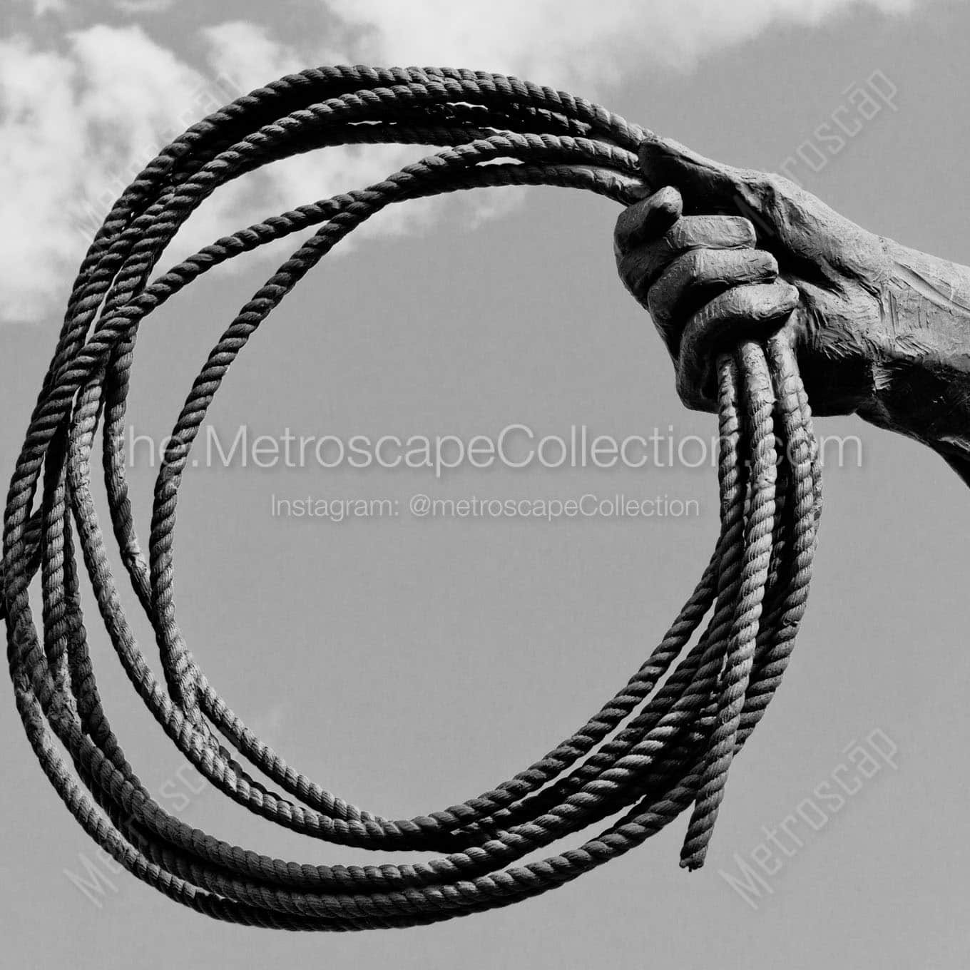 spool of rope in cowboy hand Black & White Wall Art